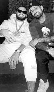 Black and white photo of Nick Kyrgios with a rapper.
