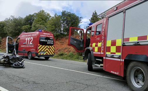 Accident scene with a wrecked motorcycle, an ambulance, and a firetruck.