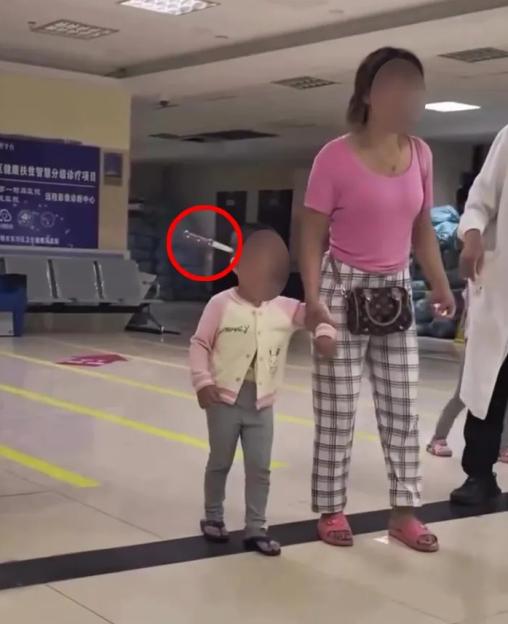 Toddler walking in a hospital with a knife in her head.