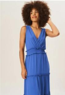 Woman in a blue tiered maxi dress.