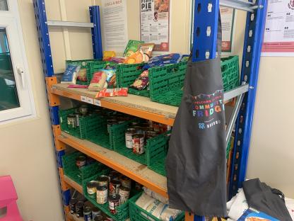 Community fridge stocked with canned goods and dry goods.