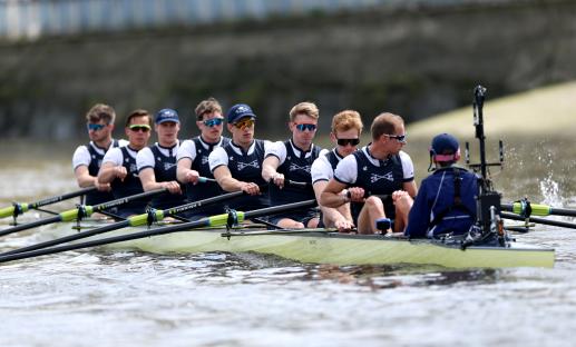 Oxford University Boat Club rowing team on the water.