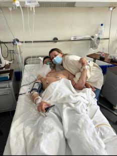 A groom-to-be in a hospital bed with his fiancÃ©e.