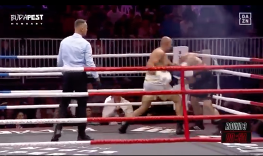 Screenshot of a boxing match in Budapest, Hungary; a boxer is down.