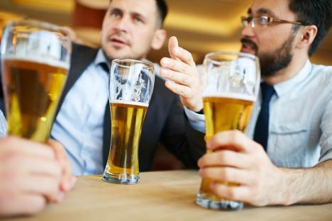 Two men drinking beer and talking.