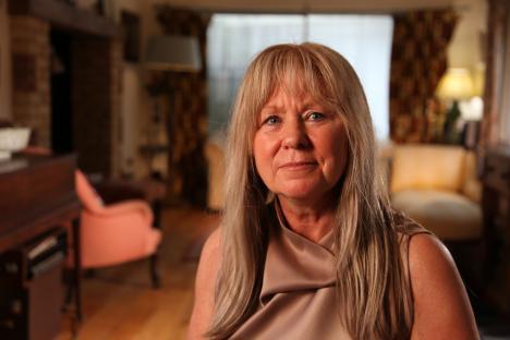 Portrait of a woman with long blonde hair.