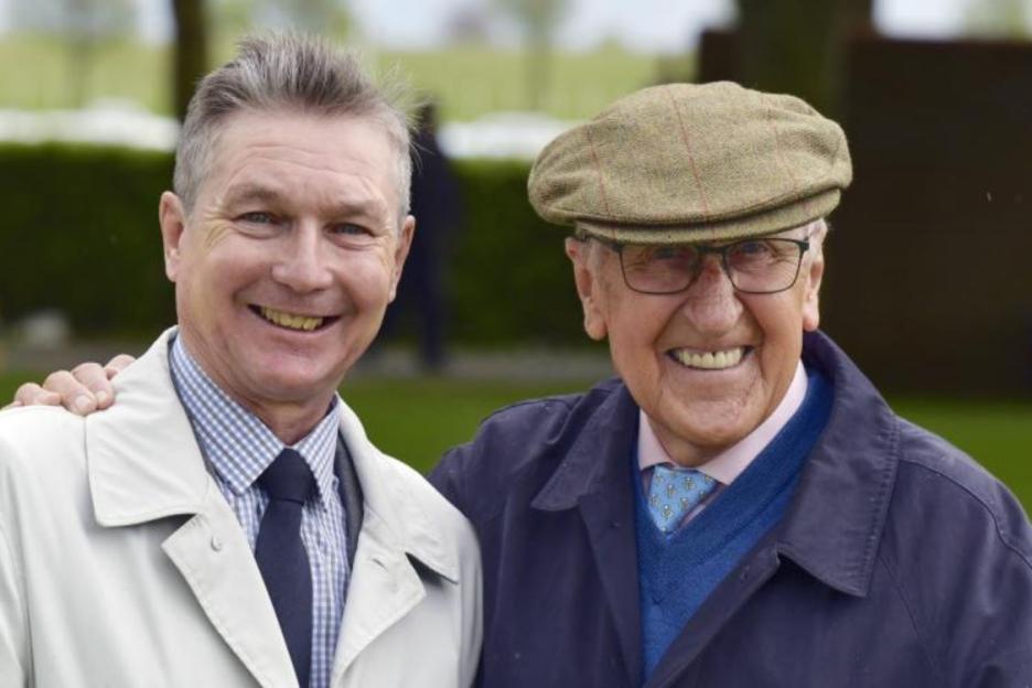 Two men smiling for a photo.