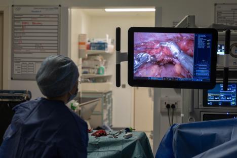 Robotic surgery in progress, viewed on a monitor in an operating theatre.