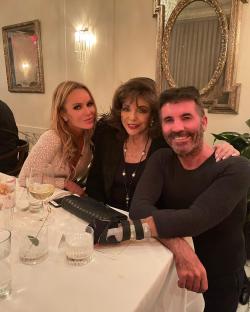 Amanda Holden, Simon Cowell, and Joan Collins at a birthday dinner.