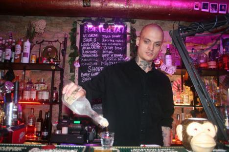 Bartender pouring a shot of liquor.