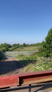 View of a gated entrance to a field.