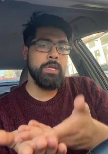 Man in car demonstrating a hand test.