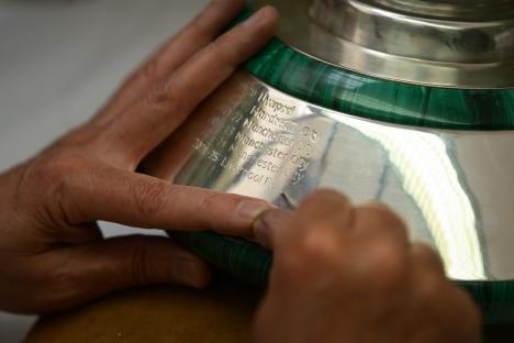 Engraving Liverpool F.C. on the Premier League trophy.