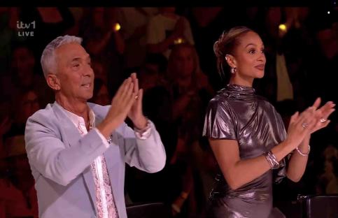 Two judges clapping during a live television show.