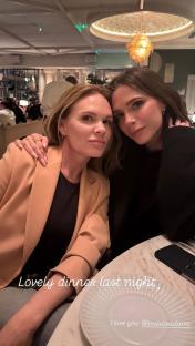 Two women smiling for a selfie at a restaurant.