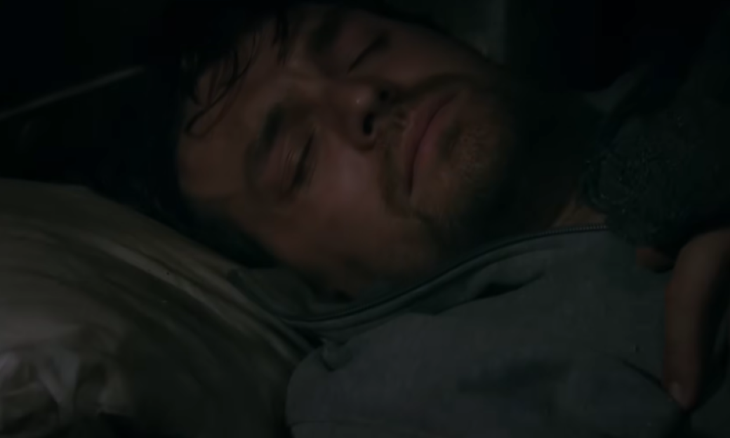A man sleeping in bed.