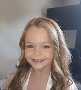 Portrait of a smiling six-year-old girl.