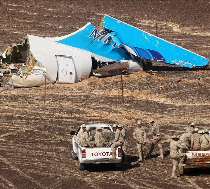 Egyptian servicemen approach the wreckage of the Metrojet Airbus A321 crash in Sinai.
