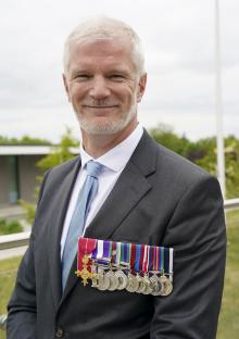 A man in a suit wearing military medals.
