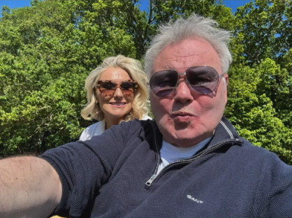 Selfie of a man and woman outdoors.
