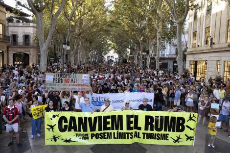 Protestors in Palma de Mallorca holding a banner that reads