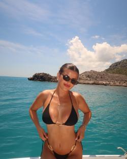 Woman in black bikini on a boat trip.