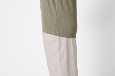 Lidl's new linen clothing collection: olive green t-shirt and beige pants.
