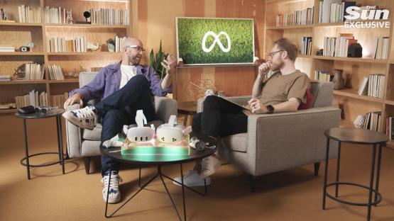 two men sit in chairs in front of a screen that says the sun exclusive