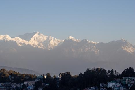 bright morning sun on Kanchenjunga mountain in the Himalayas taken from Darjeeling, India with the city in the foreground
