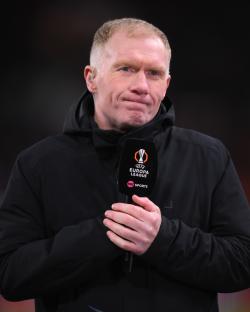 Paul Scholes holding a TNT Sports microphone during a UEFA Europa League match.