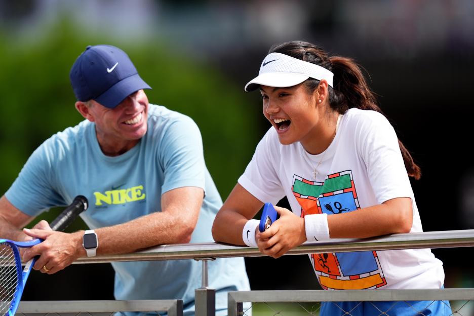Emma Raducanu and her coach, Mark Petchey, smiling during a practice session at Wimbledon.