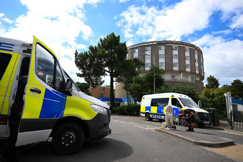Police vans outside The Roundhouse hotel during a demonstration.