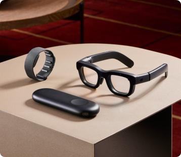 a pair of glasses a watch and a charger on a table