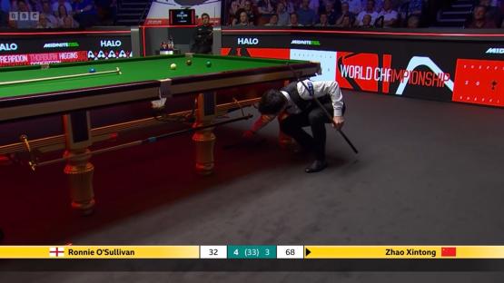 Ronnie O'Sullivan examining a snooker table leg during a match.