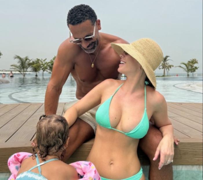 Rio Ferdinand and his wife Kate Ferdinand with their child in a pool in Dubai.