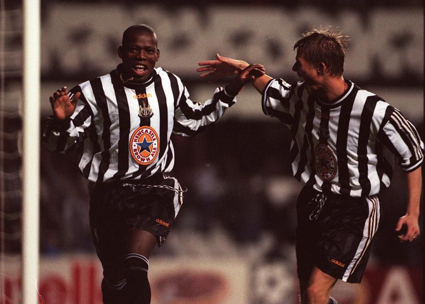 Faustino Asprilla celebrating his third goal with Jon Dahl Tomasson.