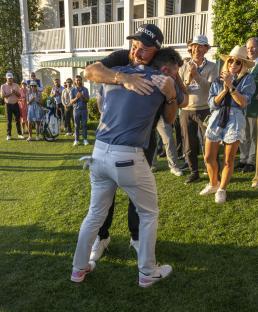Rory McIlroy and Shane Lowry embracing after McIlroy wins a golf tournament.