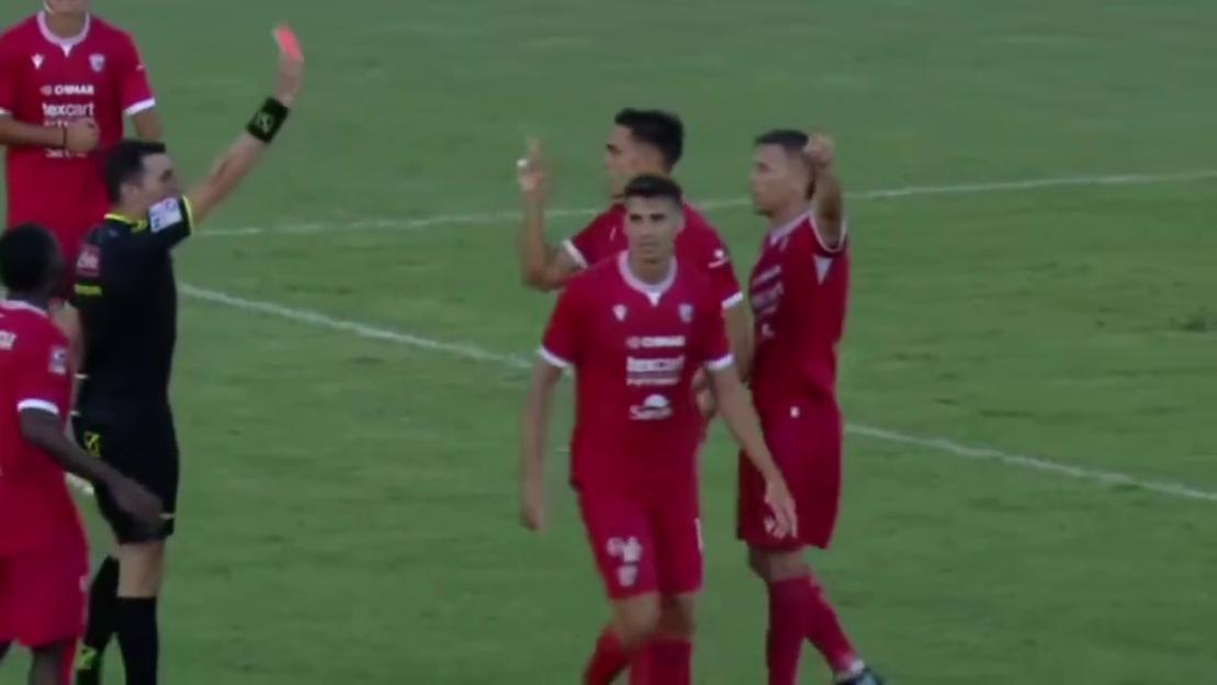 Referee showing a red card to a soccer player.