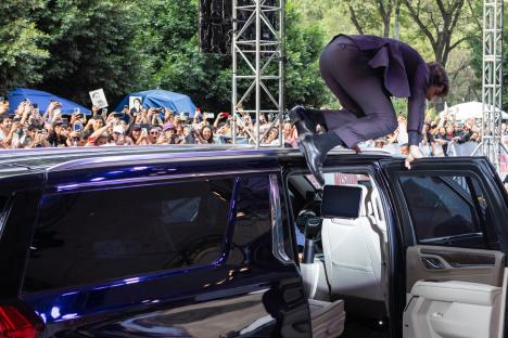 Tom Cruise jumping onto a car at a Mission: Impossible premiere.