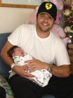 Man holding newborn baby.