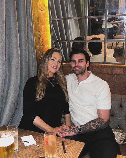 Adam Collard and Laura Woods sitting together.