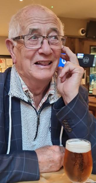 Mr. Peter Skilton holding a drink.