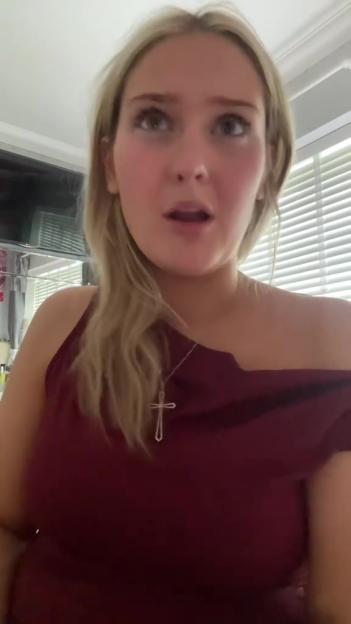 A pregnant woman speaking to the camera.