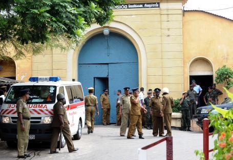 Sri Lankan policemen outside Colombo's main jail after a drug raid.