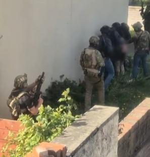 Police officers apprehending suspects.