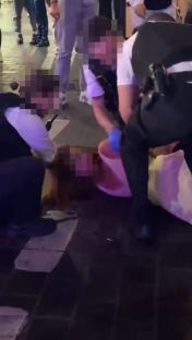 Police officers arresting a person on the ground.