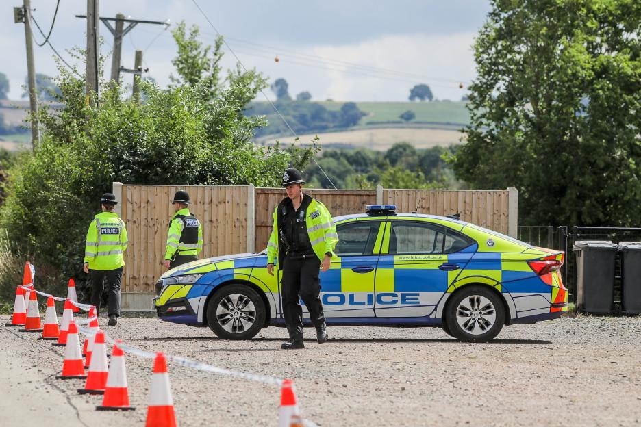 Police officers at a summer camp following a suspected poisoning.