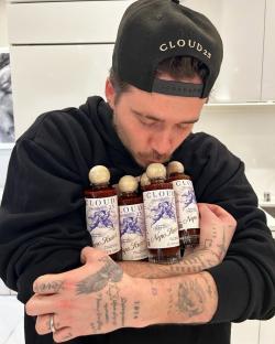 Brooklyn Beckham hugging bottles of Cloud 23 Nepo Sauce.