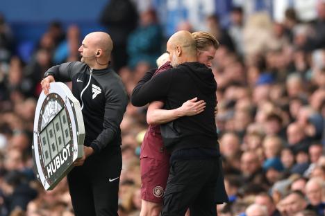 Pep Guardiola embracing Kevin De Bruyne.