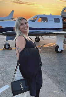 Woman standing in front of a private jet.